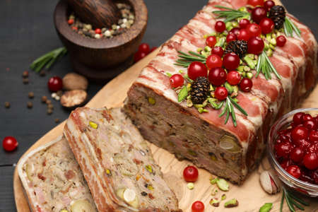 Traditional French terrine covered with bacon on dark wooden backgroundの写真素材