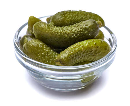 Bowl of Tasty canned Whole green cornichons isolated on a white backgroundの写真素材