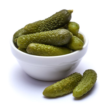 Bowl of Tasty canned Whole green cornichons isolated on a white backgroundの写真素材