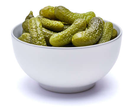 Plate of Tasty canned Whole green cornichons isolated on a white backgroundの写真素材