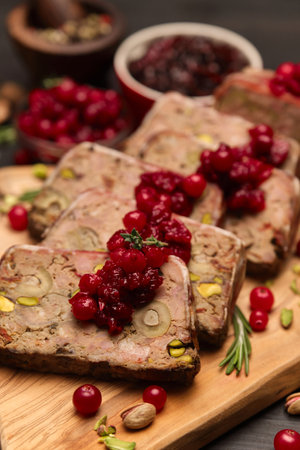 Sliced Traditional French terrine covered with bacon on dark wooden backgroundの写真素材
