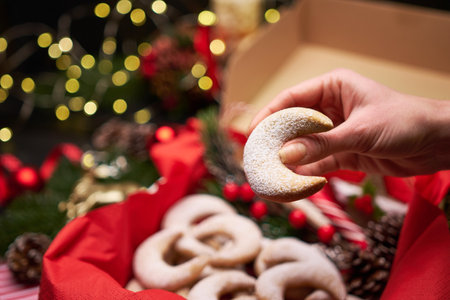 Woman holding Traditional German or Austrian Vanillekipferl vanilla kipferl cookieの写真素材