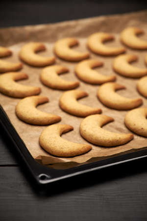 Baking tray with traditional German or Austrian Vanillekipferl vanilla kipferl cookies with ground nuts and vanilla. High quality photoの写真素材