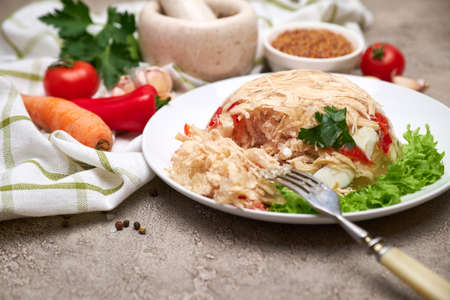 Delicious chicken aspic on a plate on concrete tableの写真素材