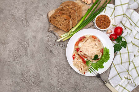 Delicious chicken aspic on a plate on concrete table