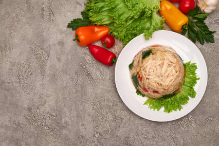 Delicious chicken aspic on a plate on concrete table