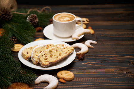 Sliced Traditional Christmas stollen cake with marzipan and dried fruit with New Year decorationsの写真素材