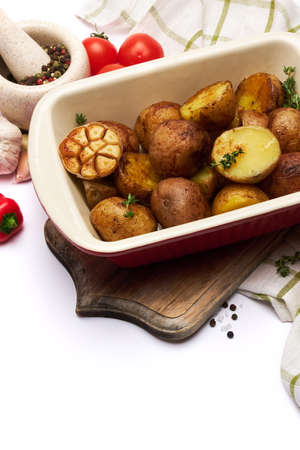 Baked potato in baking dish pot isolated on white background. High quality photoの写真素材