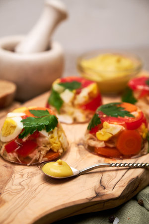 Portion of delicious chicken aspic on serving board on concrete table