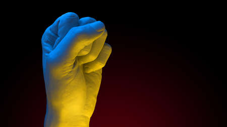 Fist in colors of Ukrainian Flag raised to fight and resist russian agressionの写真素材