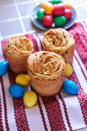 Easter cake and eggs on traditional ukrainian embroidered towel