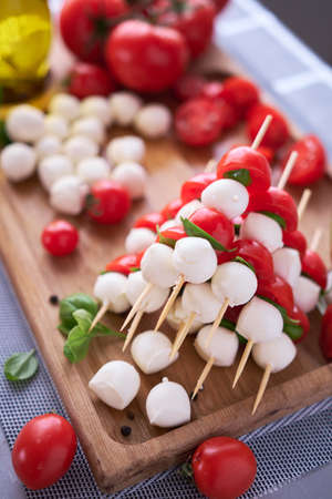 Caprese salad - Mini mozzarella cheese in glass bowl, tomato and basilの写真素材