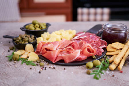 Italian antipasto meat platter - prosciutto ham, bresaola, salami and parmesanの写真素材