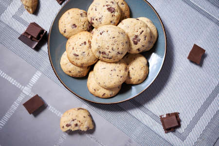 Chocolate chip cookies on ceramic plate at domestic kitchen