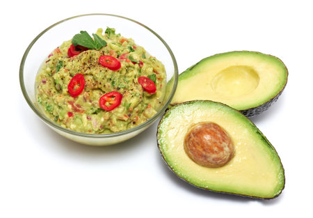 Healthy vegetarian organic guacamole Mexican dip sauce served in glass bowl isolated on white backgroundの写真素材