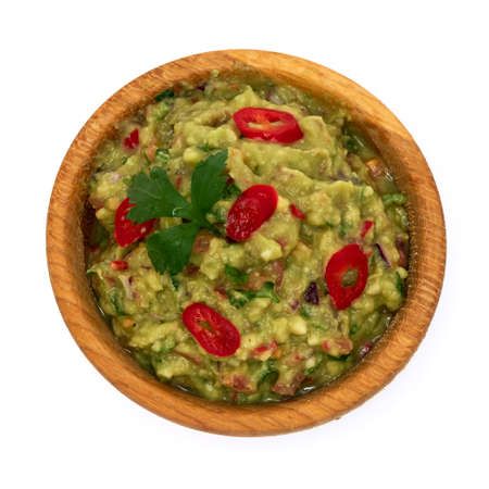 Wooden bowl of guacamole dip sauce isolated on white backgroundの写真素材