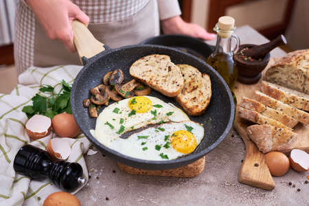 Close up view of the fried egg on a frying panの写真素材
