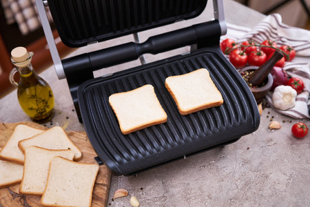 Morning homemade snack - Toast bread pan fried on black electric kitchen grill