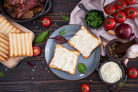 making bacon and cream cheese sandwich - ingredients on wooden tableの写真素材