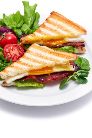 French toasts with fried eggs, cream cheese, salad and baconの写真素材