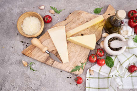 Parmesan cheese and knife on a wooden cutting boardの写真素材