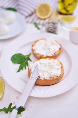 Grilled buns with cream cheese smeared with poached eggs on backgroundの写真素材
