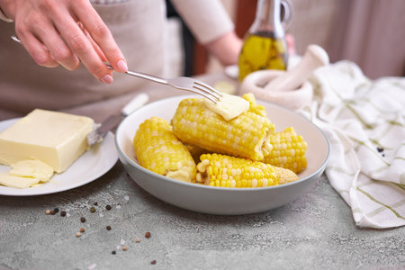 Cooked corn cobs on a plate at domestic kitchen