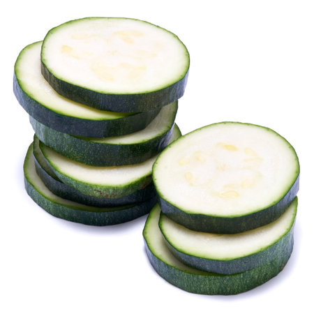Sliced zucchini circles isolated on white backgroundの写真素材