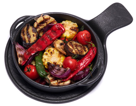 Grilled vegetables in black ceramic plate isolated on white backgroundの写真素材