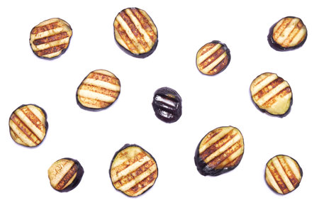 Slices of eggplant roasted on a grill with stripes from a grill isolated on white backgroundの写真素材