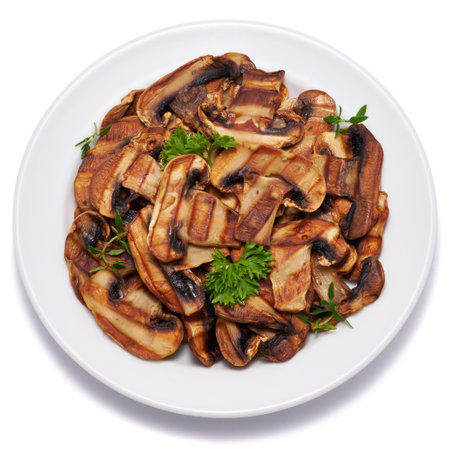 Grilled Slices of champignon mushrooms with stripes from a grill in ceramic plate isolated on white backgroundの写真素材