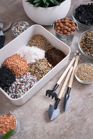 plastic box for soil substrate preparation for transplanting houseplants on concrete backgroundの写真素材