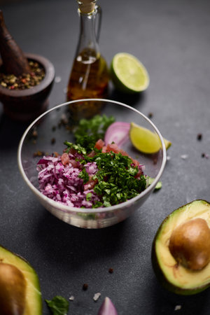 cooking traditional tuna tartare - chopped tuna, cilantro and onion in a glass bowlの写真素材