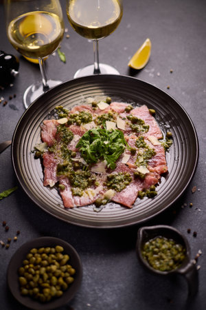 tuna carpaccio - slices of fresh raw tuna fillet on black ceramic plateの写真素材