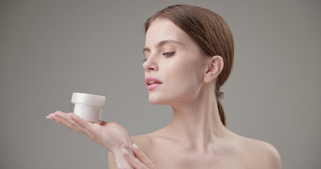 Beauty, health, cosmetics, anti-aging therapy and skin care concept - young beautiful brunette...