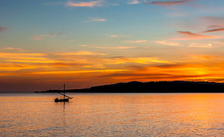 fishing boat at the sunsetの写真素材