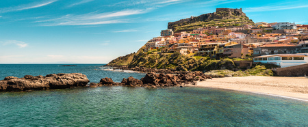 beach near the city of castelsardo in a sunny dayの写真素材