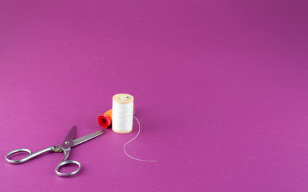 Closeup of sewing tools on colored background