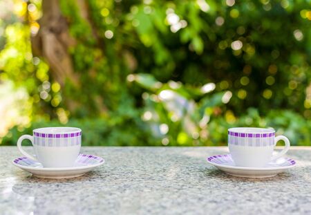 Breakfast in the garden with two little cups of coffeeの写真素材
