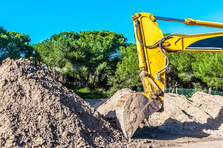 Bulldozer working near a forest in a sunny dayの写真素材