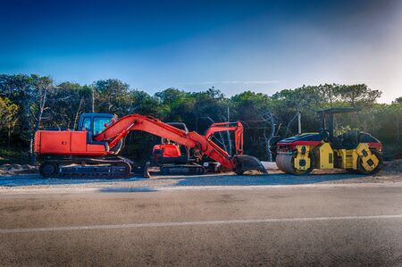 Bulldozer working near a forest in a sunny dayの写真素材