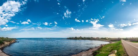 Panoramic landscape of small gulf near Stintino in a sunny and cloudy day of spring - Sardiniaの写真素材