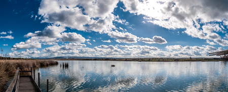 Landscape of pond with under dramatic clouds after the storm - Platamona pond - Sardiniaの写真素材