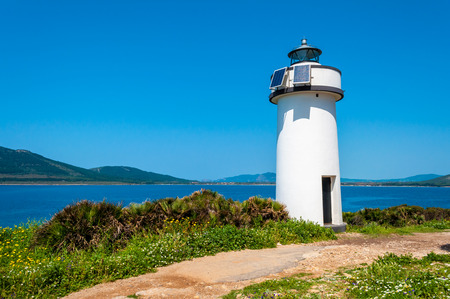 Lighthouse on sardinian coast near Maristella, near the city of Alghero, in a sunny dayの写真素材