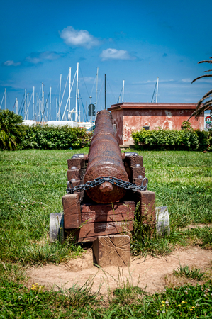 ancient cannons on the harbor of Porto Torres in a sunny day of springの写真素材