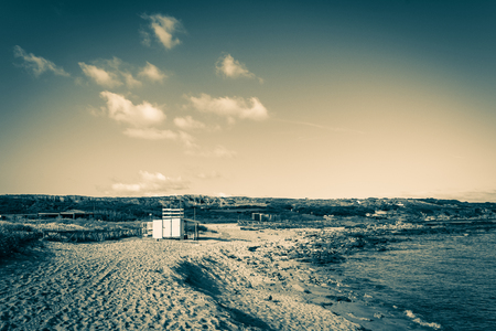 View of sardinian coast and beach of Porto Ferro in a cloudy morning of summerの写真素材