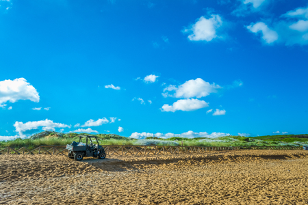 Black quad on the sardinian beach of Porto Ferro in a cloudy morning of summerのeditorial素材