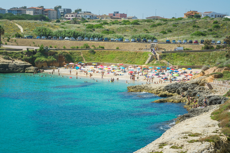 view of crowded sardinian beach of Balai, inside the city of Porto Torres, in sunny day of summerの写真素材