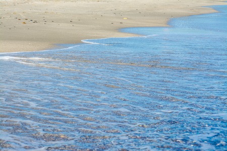 crystal clear water on the water's edge in summer morningの写真素材