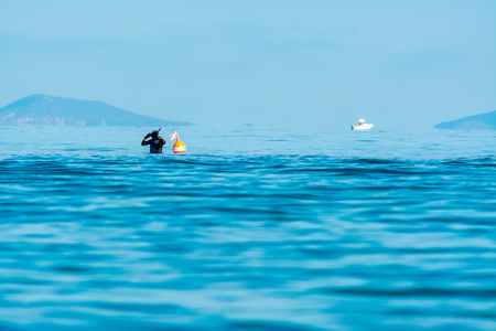 diver prepares himself in the seaの写真素材